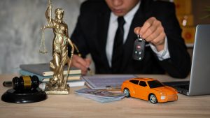 Small,Cars,And,Scales,Goddess,Of,Justice,With,Hammer,,Money auto accident attorney Utah