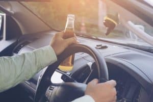Drunk,Young,Man,Drives,A,Car,With,A,Bottle,Of defining reckless driving auto accident