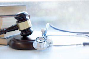 Gavel,And,Stethoscope.,Medical,Jurisprudence.,Legal,Definition,Of,Medical,Malpractice. Personal Injury Settlement Considered Income